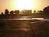Rubbish bags glisten as dawn breaks over the desert