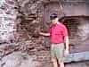 Roger examines a shell lodged in the wall of Fort Sumter
