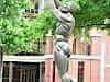 Kunter Kinte holds child aloft outside the King Memorial Centre