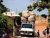 collecting the bales of recyclables the locals have scavenged from the tip