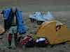 Dave working out his sleeping bag will Jo sorts her sleeping quarters