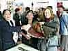 Jo makesa purchase, the ladies happily wave the cash received