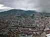 The city spreads across a basin between volcanoes